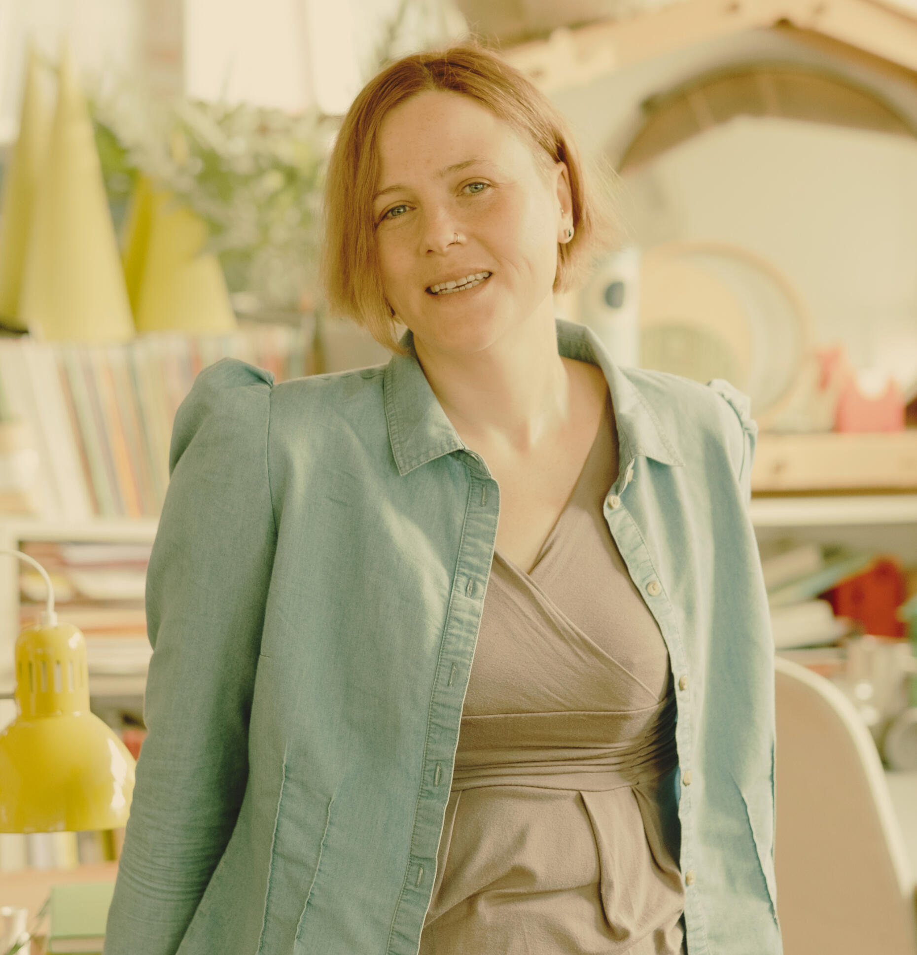 Supporting the clean energy with specialist copywriting and content marketing solutions Image of a woman standing and smiling in an office powered by clean energy.